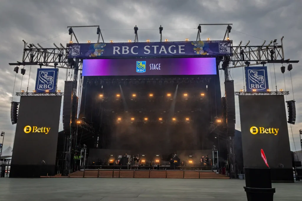 A photograph of the RBC stage at Bluesfest in Ottawa, with the Betty logo shown onscreen.